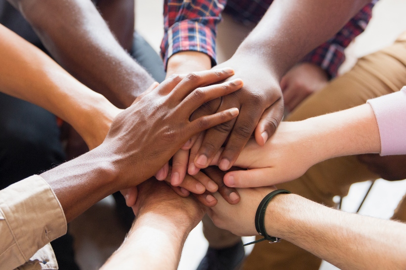 People joining hands in community