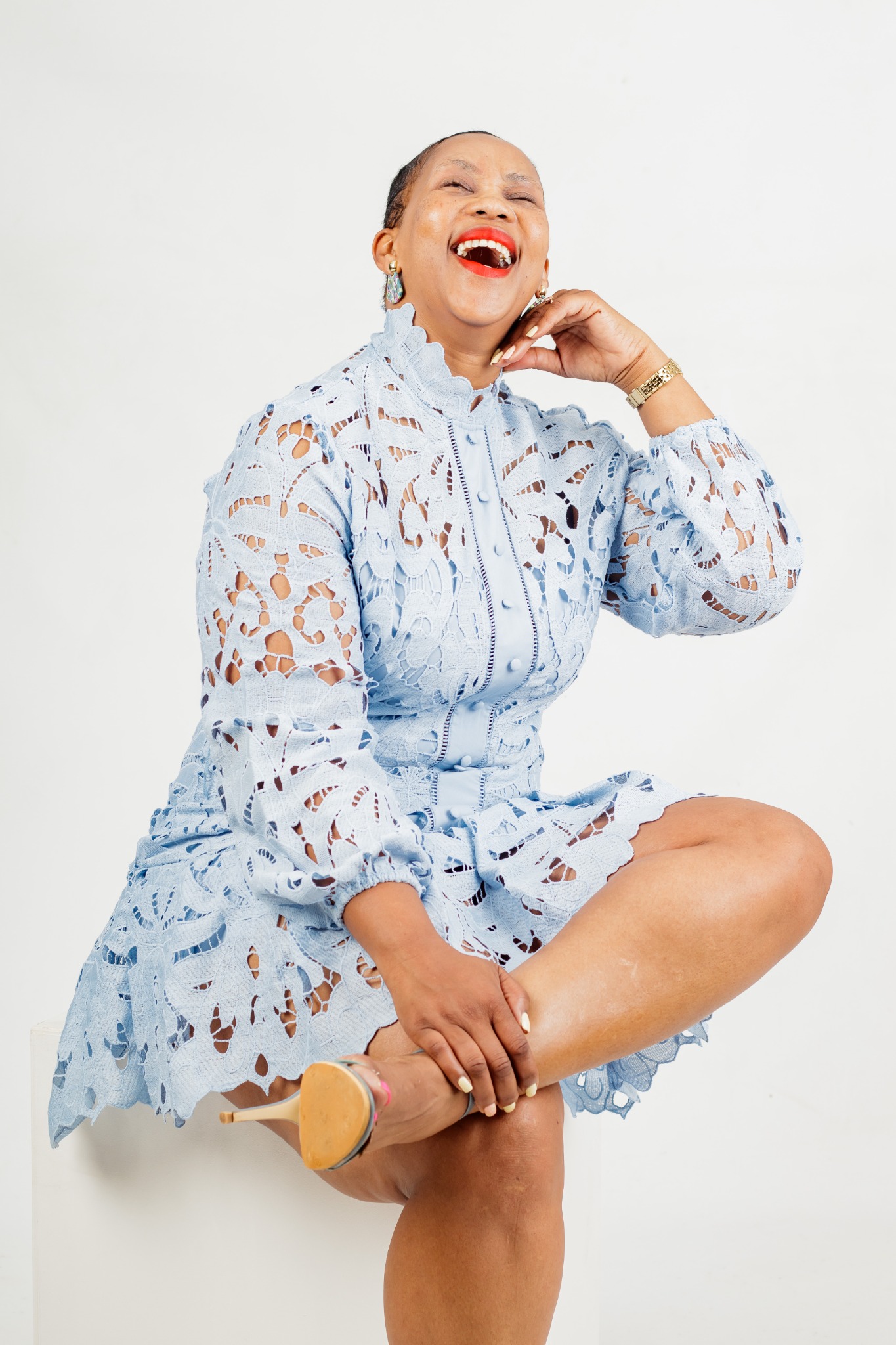 Mphathi smiling in a light blue outfit